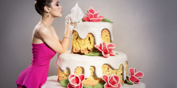 How did the tradition of women jumping out of huge cakes start?
